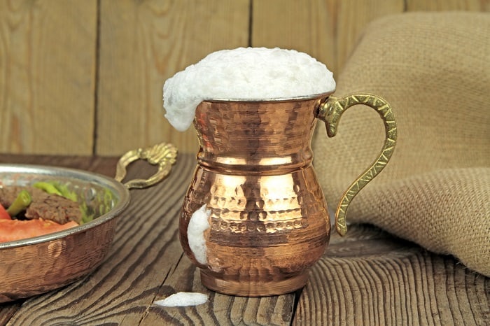 Ayran - traditional Turkish fermented drink in a cooper glass