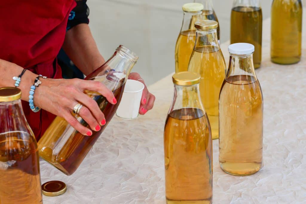 Woman bottling kombucha